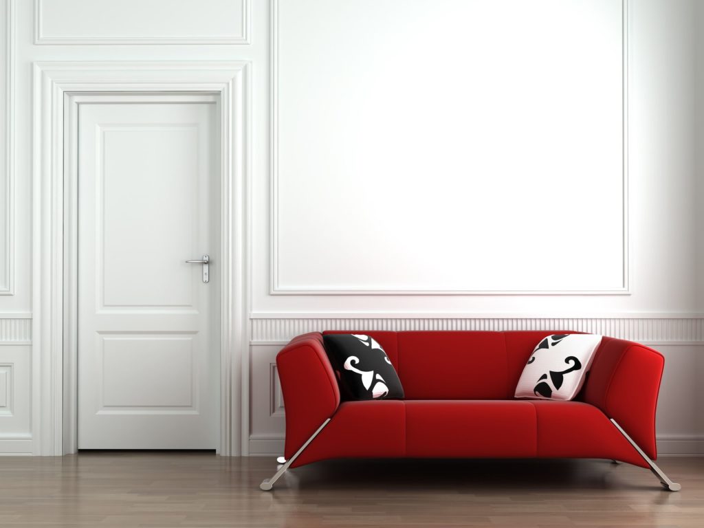 Дизайнерский прямой красный диван у белой стены