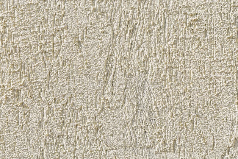 Abstract light beige grainy background with the texture of coarse grained new decorative plaster. Construction and repair. Abstract light beige grainy stock image