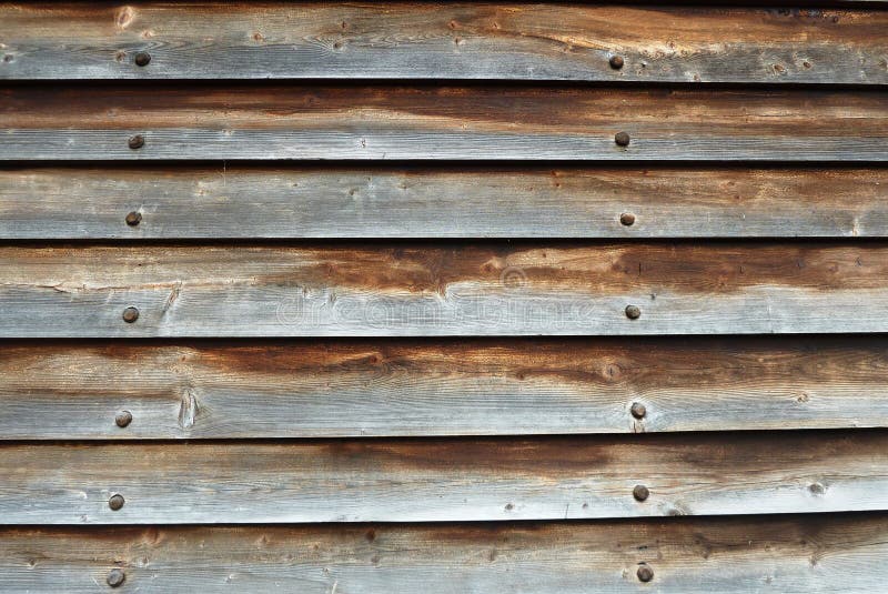 Aged overlapped wooden boards with black nails royalty free stock photo