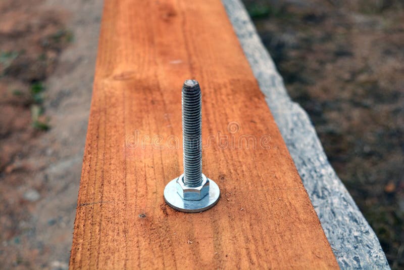 Anchor with bolt on new house foundation. Anchor with steel bolt on new house foundation stock images