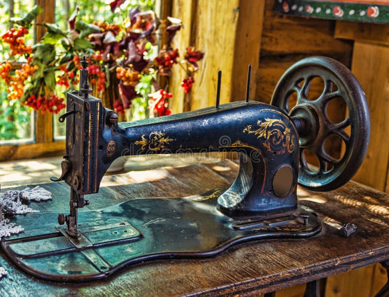 Antique sewing machine. In the interior of the ancient Russian hut royalty free stock photos