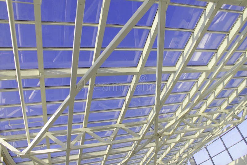 Architecture, white beams, ceilings, glass roof, blue sky. Architecture, white beams, ceilings glass roof blue sky royalty free stock photography