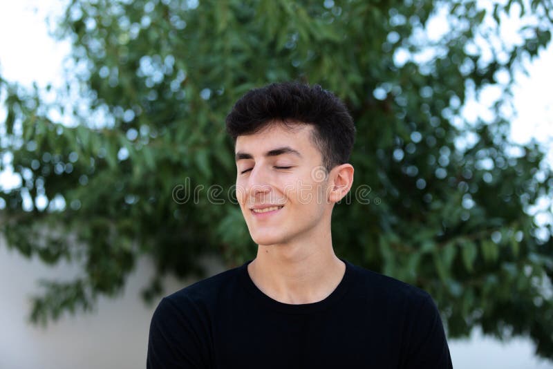 Attractive teenager guy in a park stock photos