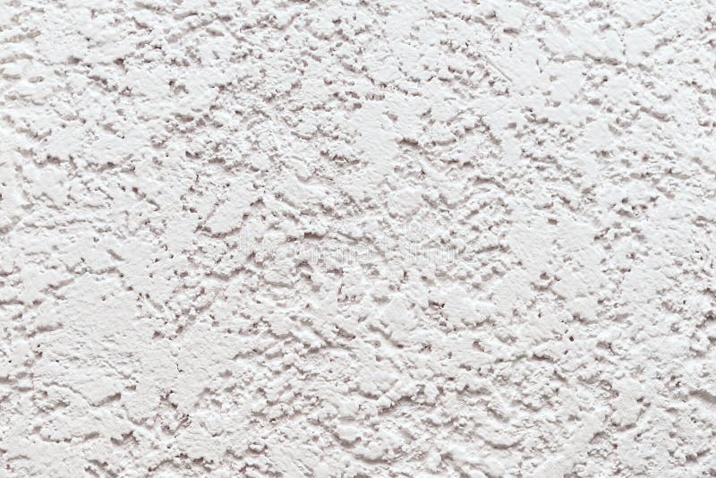 Embossed white wall trimmed with decorative plaster. Background of embossed white wall trimmed with decorative plaster. Repair and construction of the house royalty free stock image