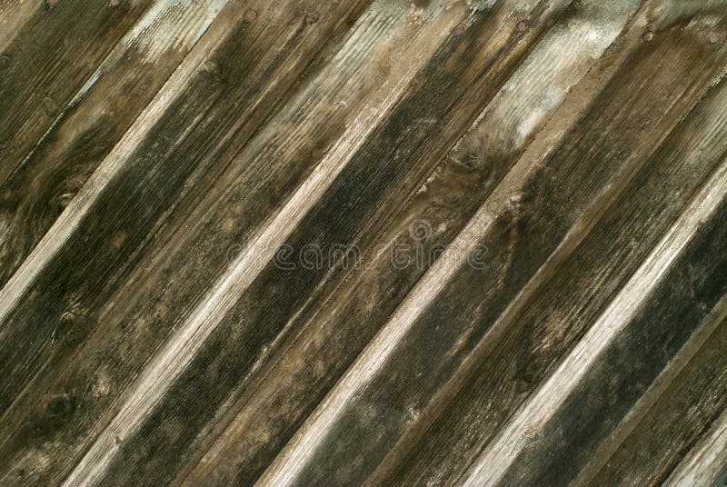 Background, texture: wall of diagonal overlapping planks darkened from the time royalty free stock photo