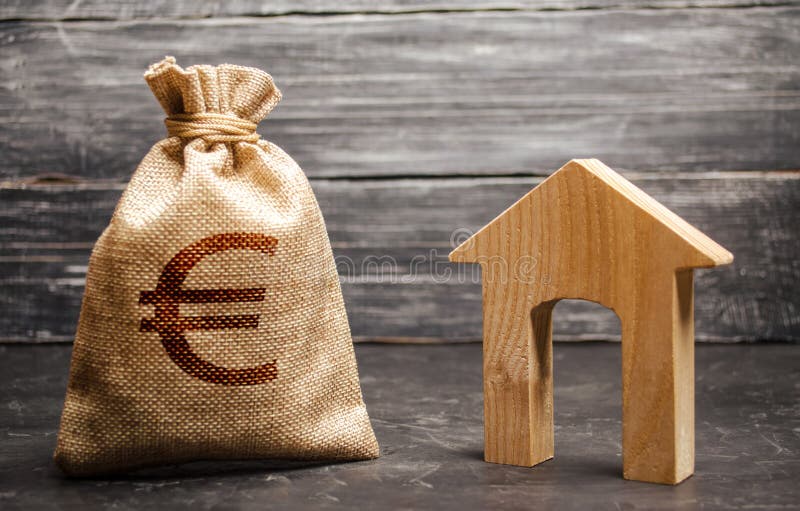 A bag with euro money and a House with a large doorway. Taxes, rental income. Building houses. rent or purchaseConcept of real. Estate acquisition and royalty free stock photo