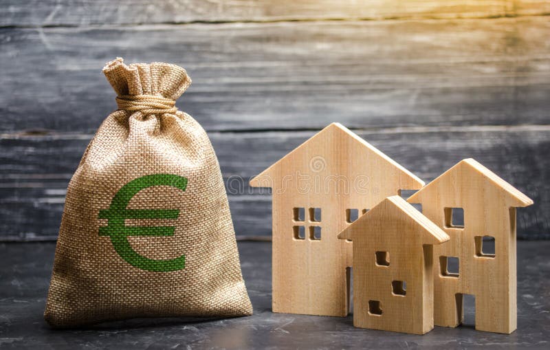 A bag with euro money and three houses. Affordable cheap loan, mortgage. Taxes, rental income. Building houses. Municipal budget. Of the community. Concept of stock photo