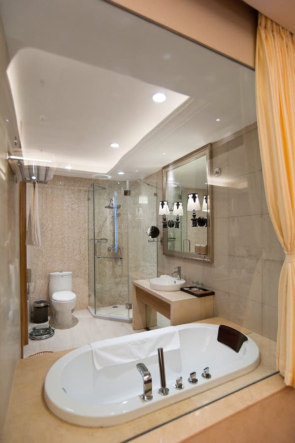 Bathroom. Simple modern bathroom,including separate shower in glass wall, bathtub, toilet, wash basin and Mirror royalty free stock photos