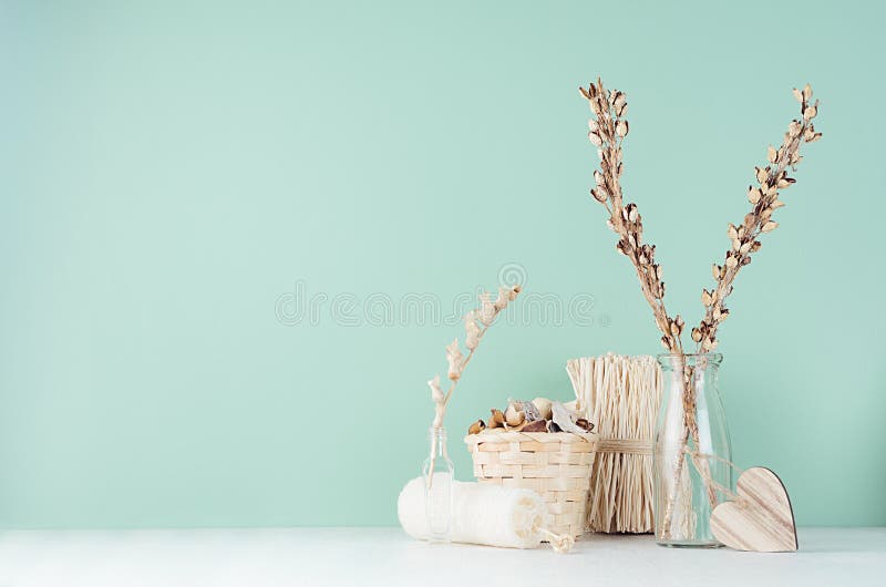 Bathroom interior with beige wooden decoration, accessories for body care -  bath sponge, dried flowers, heart on white wood table. Mint menthe stock image