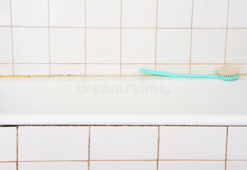 Bathroom. Old bathroom with bathtub and white tiles royalty free stock image