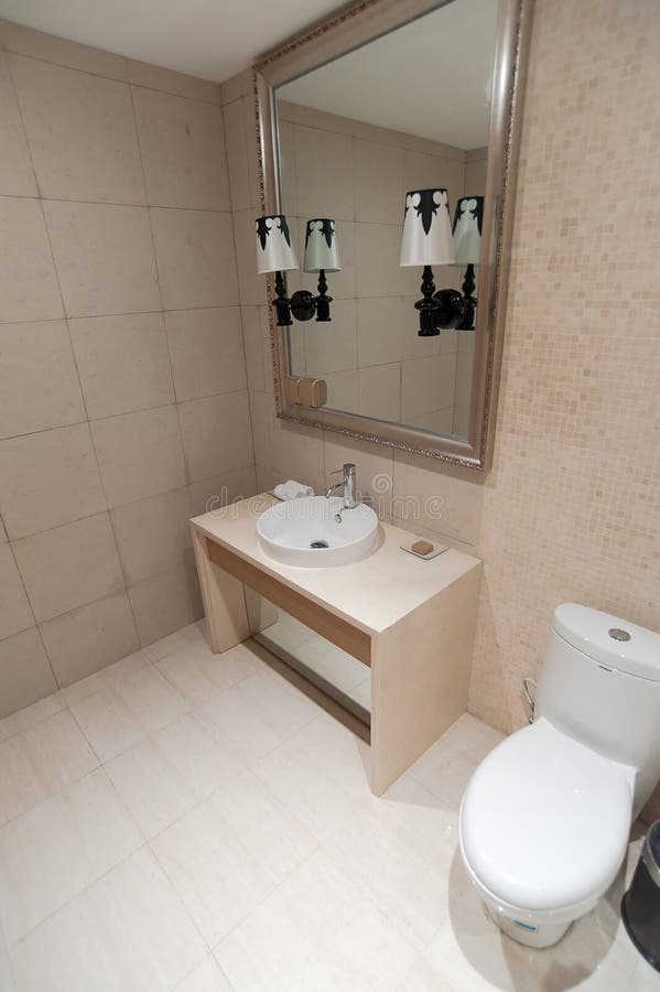 Bathroom part. A part of a simple bathroom, including basins, mirror and toilet stock images