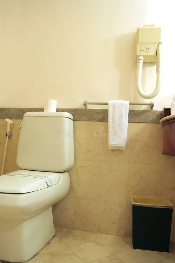 Bathroom with toilet. The towel in hotel bathroom royalty free stock photos