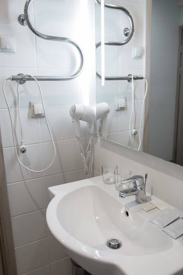 Bathroom washbasin, wall mounted hair dryer royalty free stock photography
