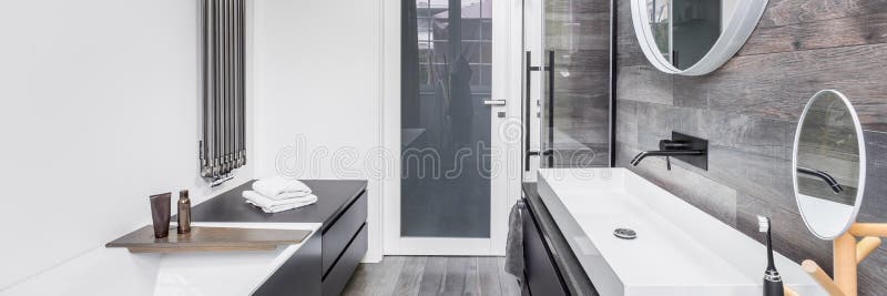 Bathroom with wood effect tiles. Elegant bathroom with white wall and wood effect tiles, panorama royalty free stock images