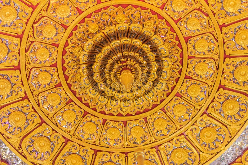 Beautiful golden decorated ceiling in lotus shape with lamp at t. He Buddhist church, Thailand stock image