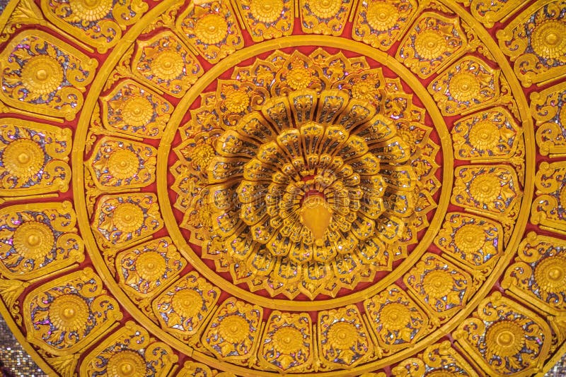 Beautiful golden decorated ceiling in lotus shape with lamp at t. He Buddhist church, Thailand royalty free stock image