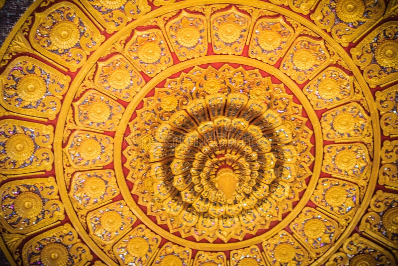 Beautiful golden decorated ceiling in lotus shape with lamp at t. He Buddhist church, Thailand stock photo