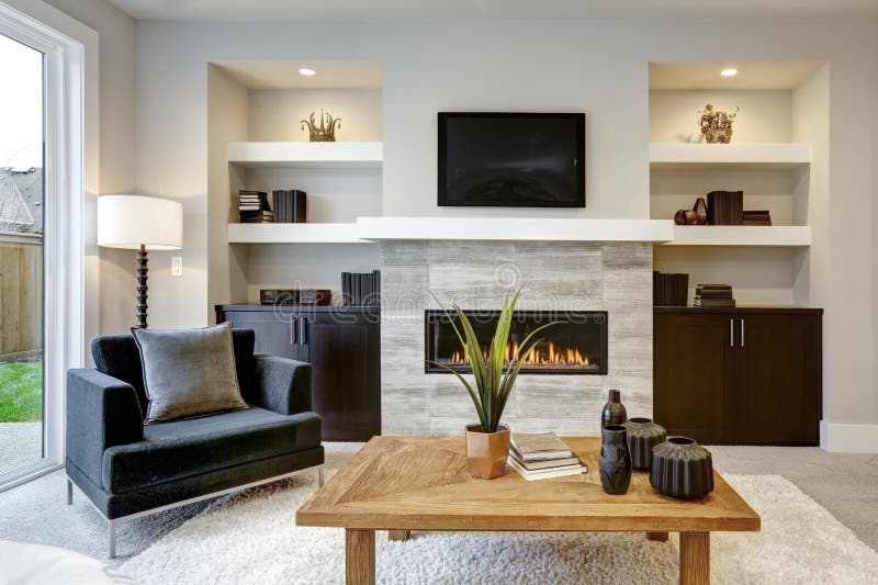 Beautiful modern living room interior with stone wall and fireplace in luxury home.  stock photos