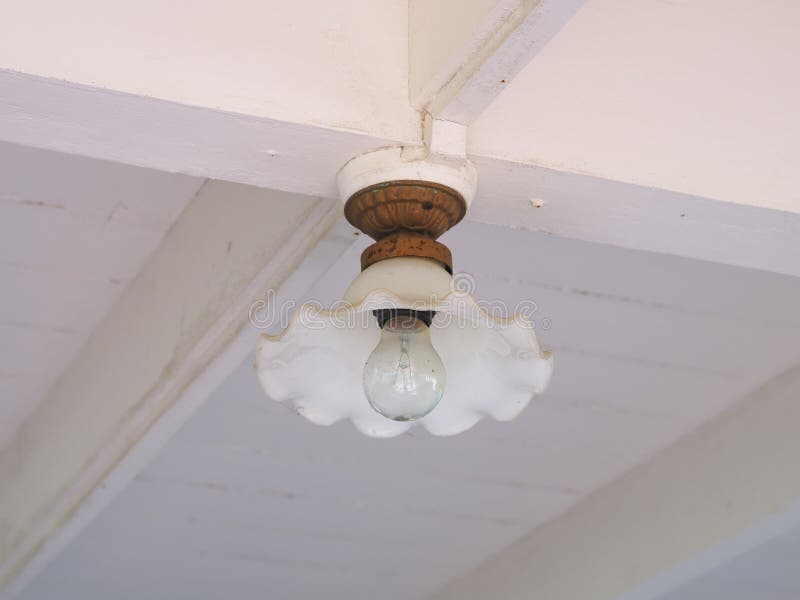 Beautiful old lamp hanging on the ceiling in interior. antique light bulb switched-off. Beautiful old lamp hanging on the ceiling in interior. antique light royalty free stock photography