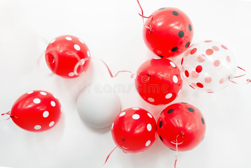 Beautiful red dotted balloons floating at white ceiling. Wedding or children birthday party decoration interior stock images