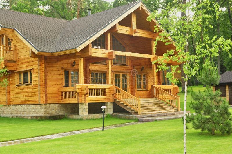 Beautiful wooden house in the forest. Wooden house in the forest with nice lawn stock images