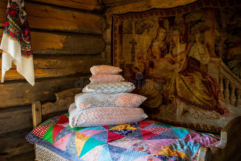 Made bed. bedroom. Interior of an old Russian hut Bed in a Russian hut. Interior items with ancient utensils Old Russian life. Bed in a Russian hut. Interior royalty free stock images