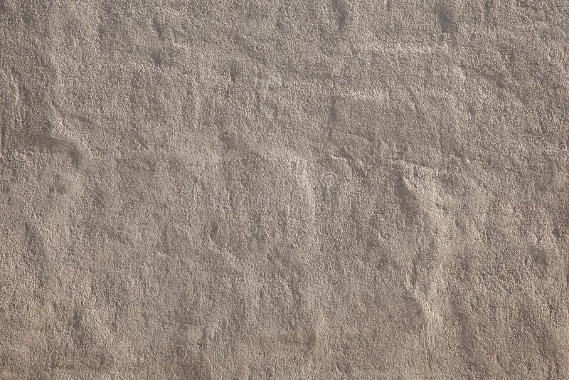 Coarse handmade sand plaster. Beige handmade coarse sand facade, Manually applied plasters, Handmade rough plaster background royalty free stock images