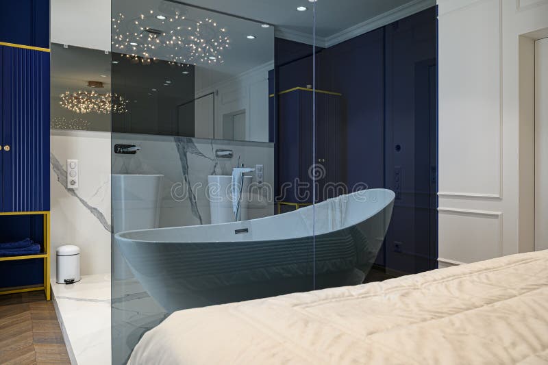 Big deluxe elegant classic bedroom with bath. Big luxury elegant classic bedroom combined with bathroom stock images