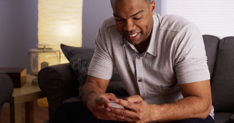 Black man texting on smartphone royalty free stock image