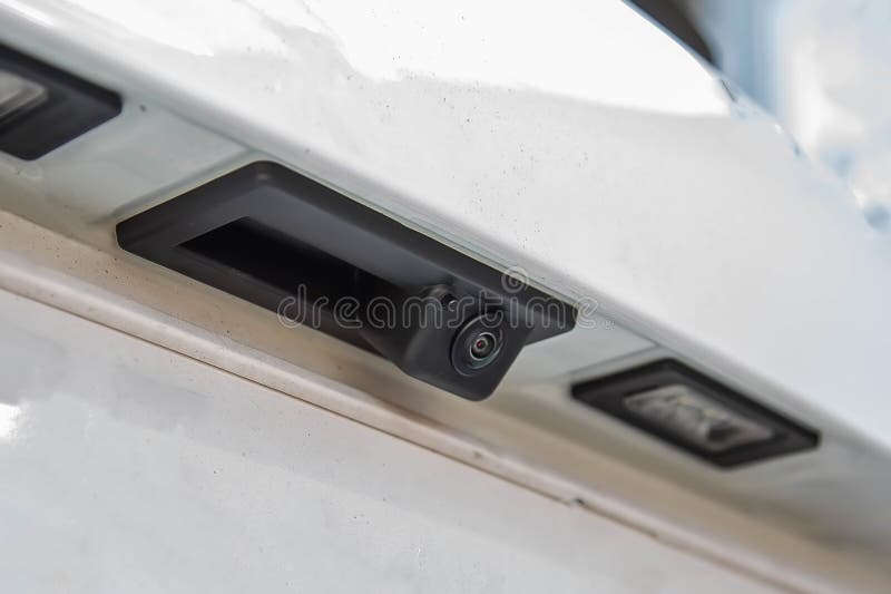 Black rear view camera with washer, car exterior. On white suv, license plate ceilings closeup.  royalty free stock images