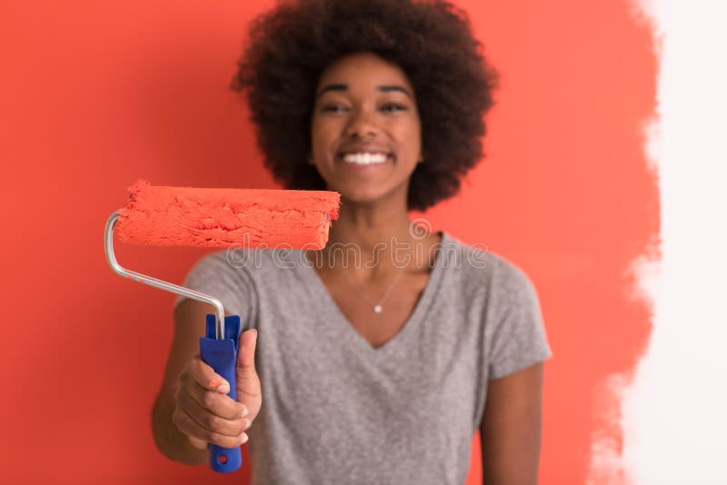 Black woman painting wall royalty free stock image