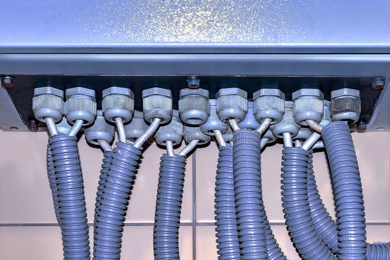 Blue switchboard and branches of electrical wires in the corrugation. stock photography