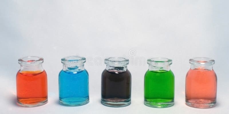 Bottles with colored liquid stock photos