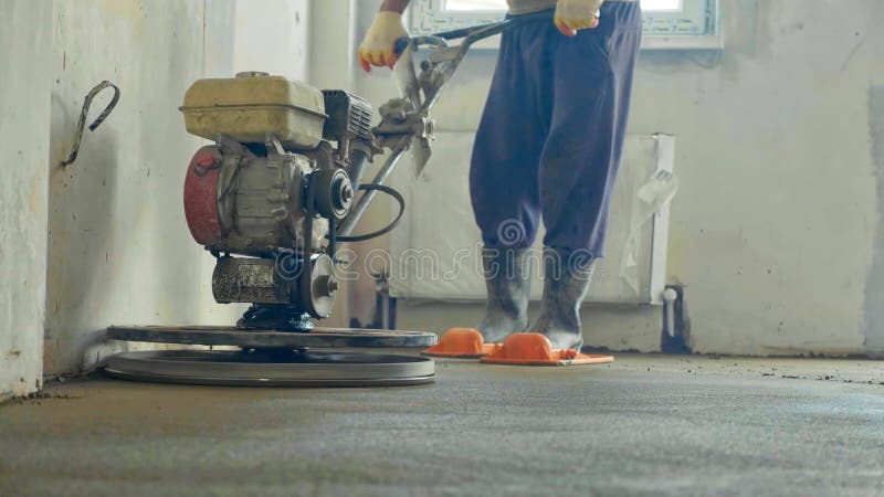 Mechanized grout screed concrete floor close-up. Builder polishing mortar floor at construction site of new appartments. Mechanized grout screed concrete floor stock photos