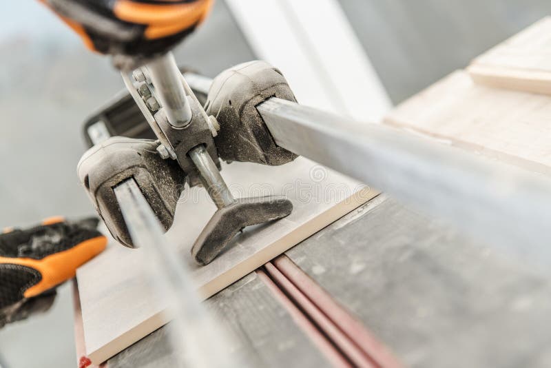 Ceramic Tiles Cutter. And Cutting Process Closeup Photo. Tile Preparation stock photos