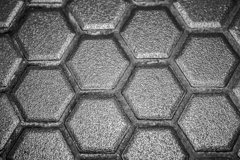 Ceramic tiles mosaic made of gray rhombuses, without grouting, the mesh-base and glue is visible. The concept of repair. Background stock image