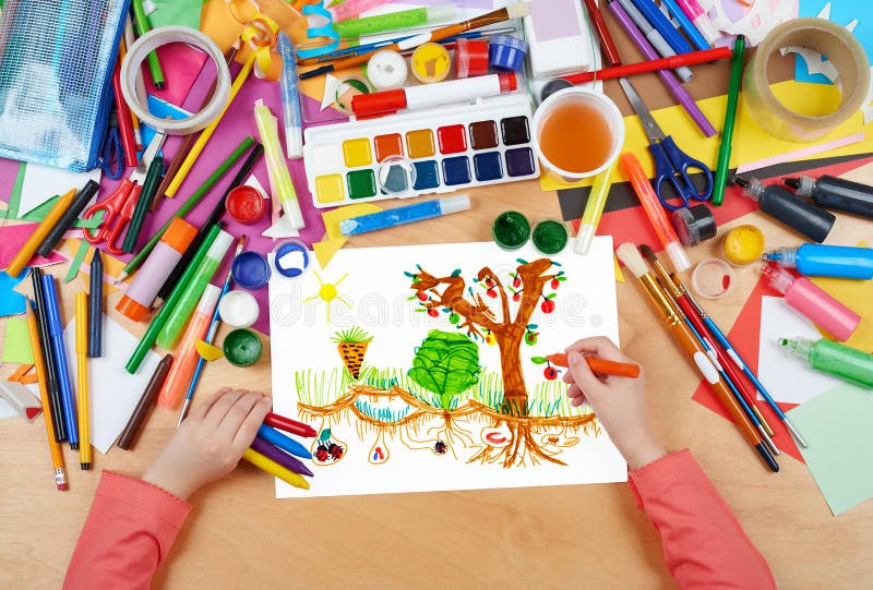 Child drawing kitchen garden with vegetables , top view hands with pencil painting picture on paper, artwork workplace royalty free stock photos