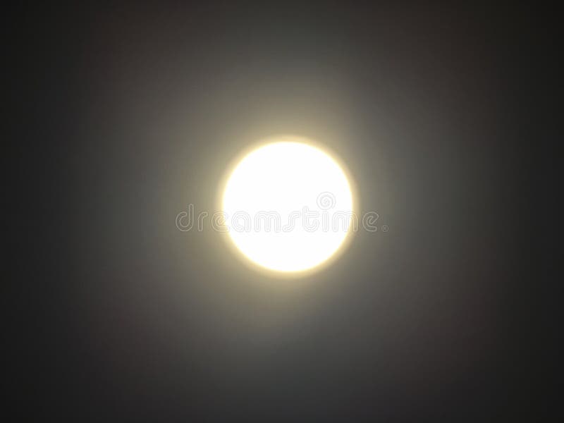 Circle warm white lighting lamp panel on ceiling by bottom view with soft focus. Light reflection like the moon in dark sky at night time royalty free stock photography