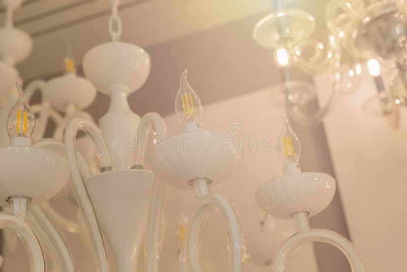 Close up on crystal of classic style chandelier, is a branched ornamental light fixture designed to be mounted on ceilings. Soft w. Arm filter, selective focus royalty free stock photo