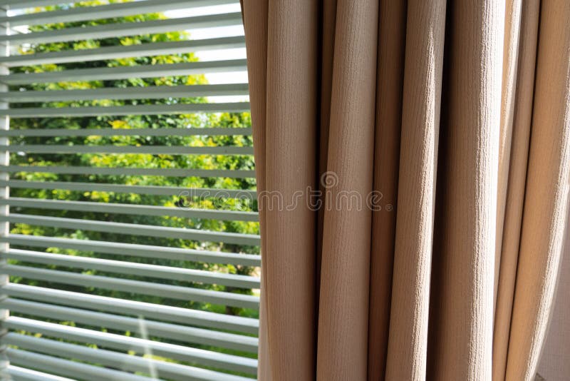 Close up of luxury brown curtains with venetian blinds in bedroom on the morning. Close up of luxury brown curtains with venetian blinds in bedroom stock photos