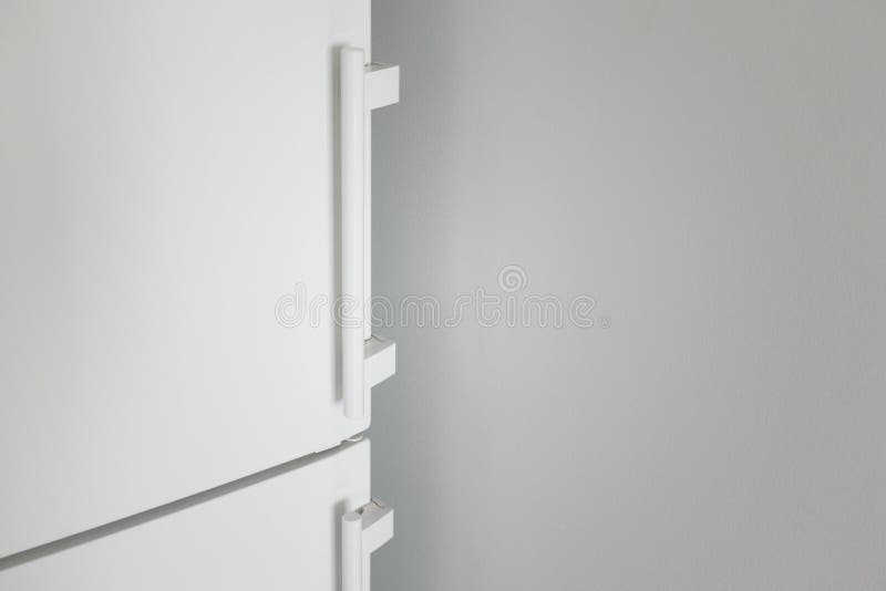 Close-up white refrigerator door and gray wall royalty free stock photography