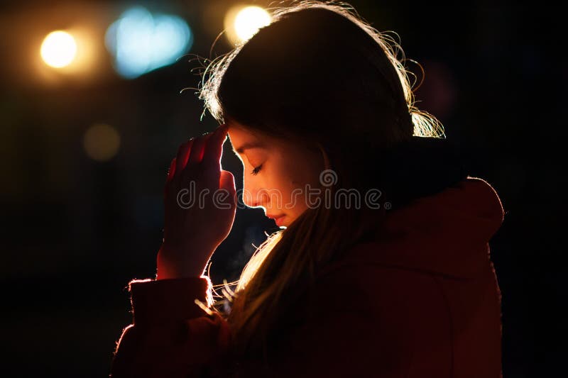 Closeup portrait of a young woman praying royalty free stock photos