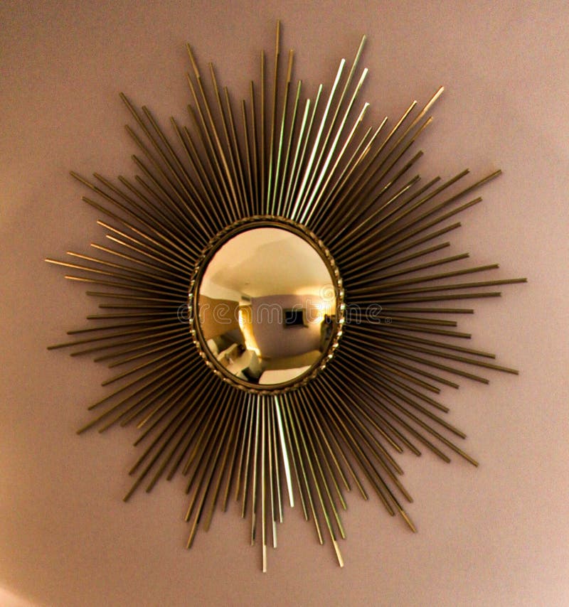 Closeup shot of a golden sun design hotel room mirror. A closeup shot of a golden sun design hotel room mirror stock images