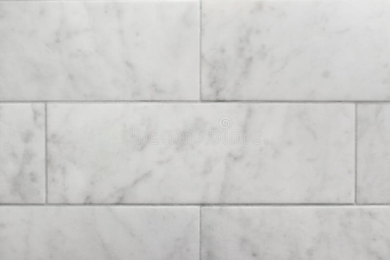 Closeup of subway tile carrara marble wall background. Closeup of subway tile carrara marble wall making a seamless background stock image