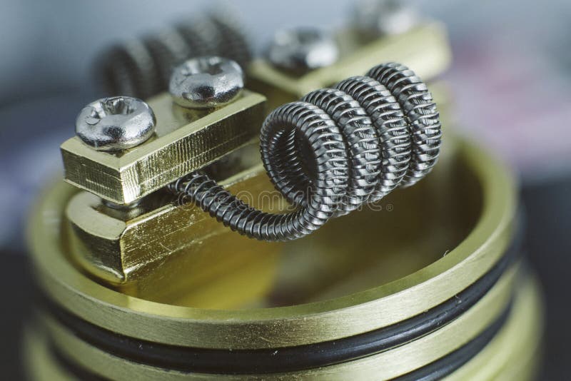 Coil for vaping. Coil on rda brass base royalty free stock photography