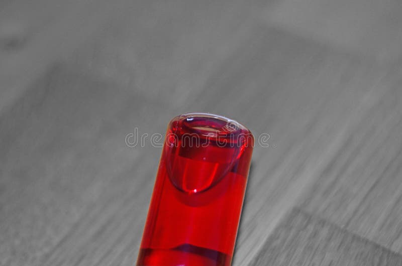Colored liquid in glass bottle. stock image