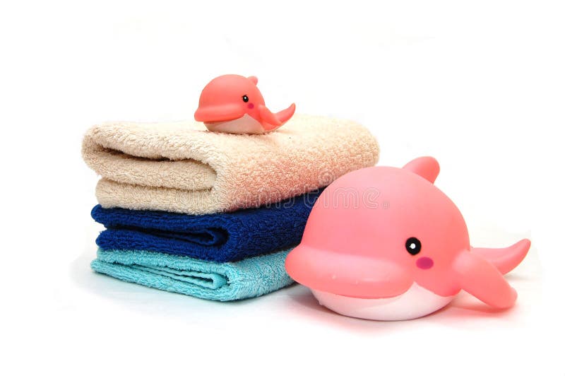 The combined colour towels with toy. The combined colour towels with a toy dolphin stock images