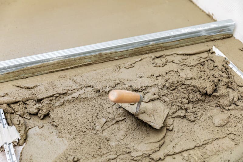 Concrete screed floor align. Trowel and rail on wet mortar royalty free stock photo