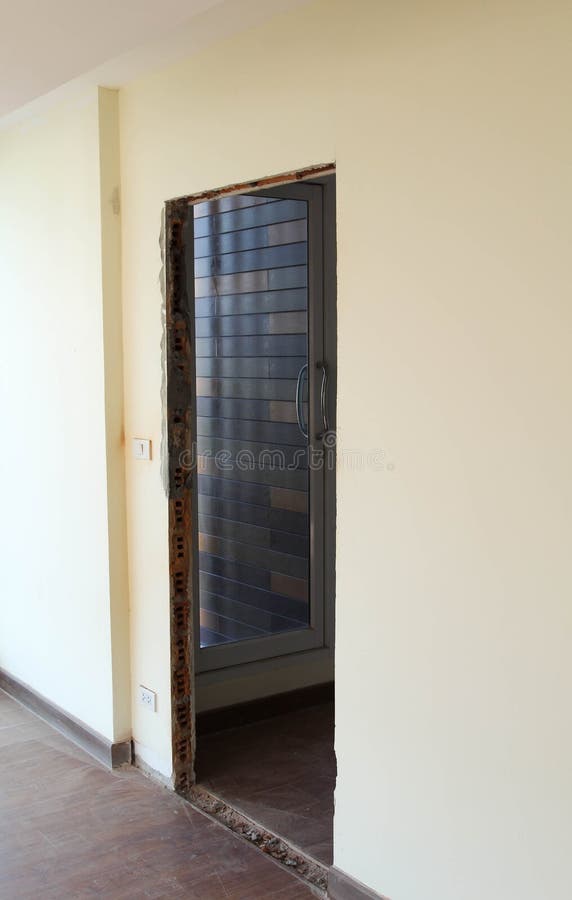 Punctured wall for door installation. Concrete wall is punctured for door installation stock images