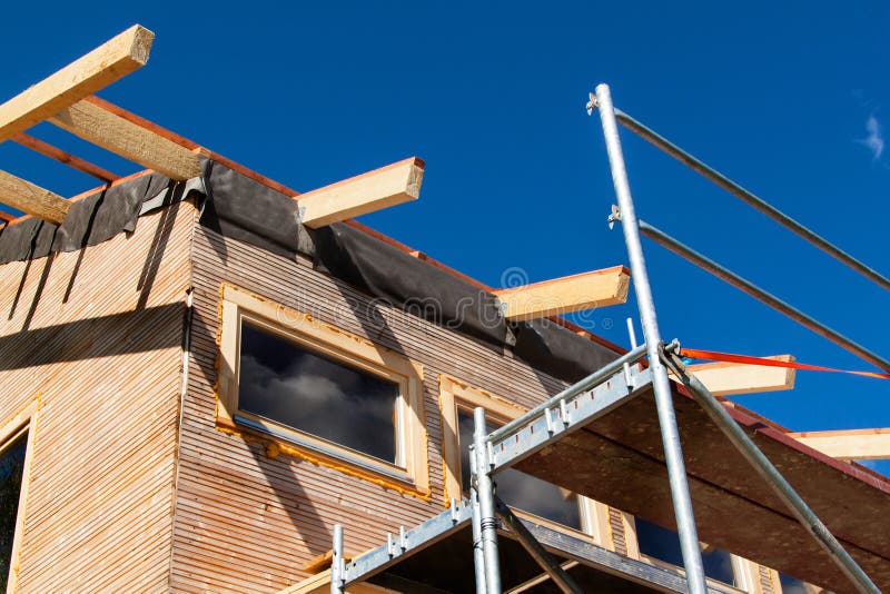 Construction of a wooden roof in an ecological house. External work on the building envelope. The wooden structure of the house ne. Ar the forest royalty free stock images